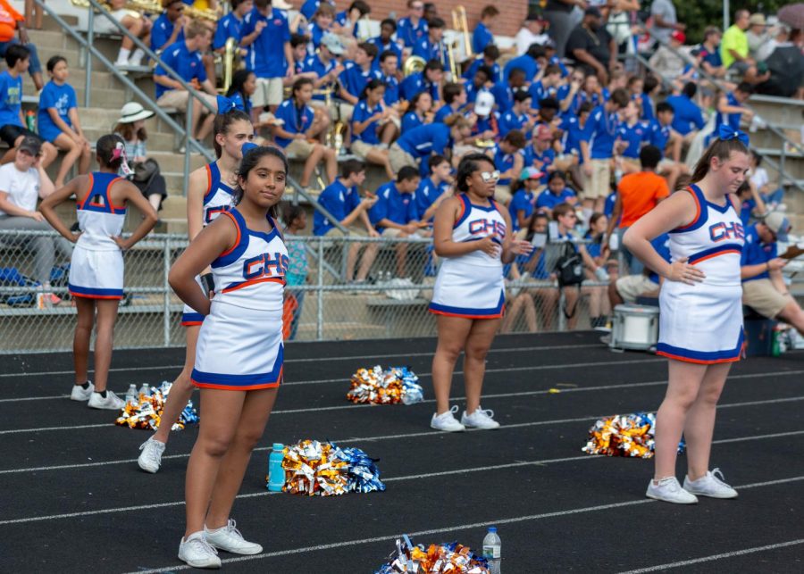 Members of the fall cheerleaders team perform at the CHS homecoming game. Some fall cheerleaders join either the dance team or the winter cheerleading team, which stands alongside the dance team at games.