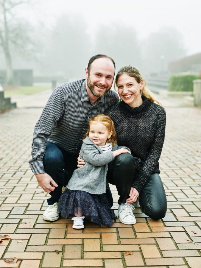 Kate Berland, Class of 1999, sits for a family photo with her two-year-old daughter and husband. Berland works in marketing at Google, but says that whats more important to the job is coming home to something thats truly important to her--her family.