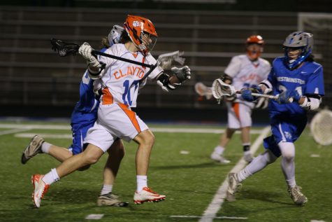 Max Murphy, class of 2017, carries the ball down the field during a lacrosse game.