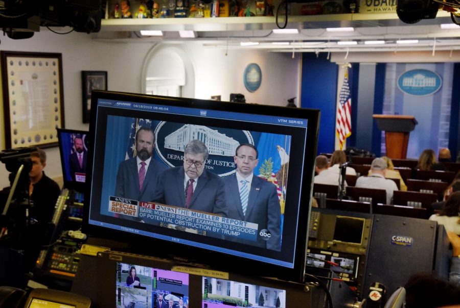 Attorney General William P. Barr is seen on TV monitors in the briefing room of the White House as he delivers remarks on the release of the report on the investigation into Russian interference in the 2016 presidential election April 18, 2019 in the White House in Washington, D.C.