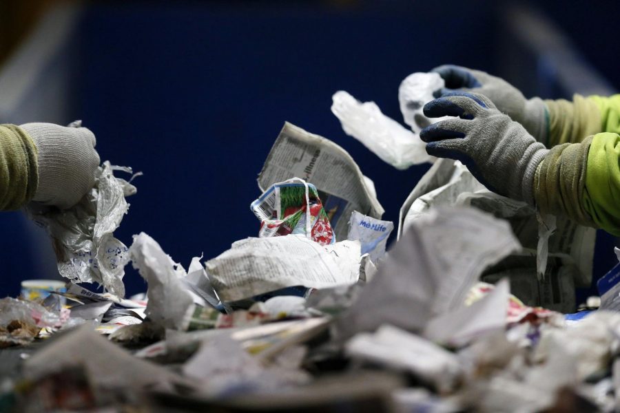 Rumpke quality control workers sort through recyclables in Columbus on February 9, 2018.