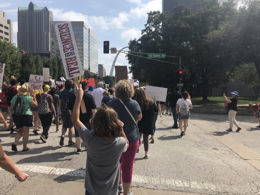 A young marcher holds a sign. 