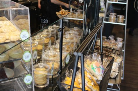 Cookies, macarons and muffins glisten in the light within the bakery display case at Colleen's.