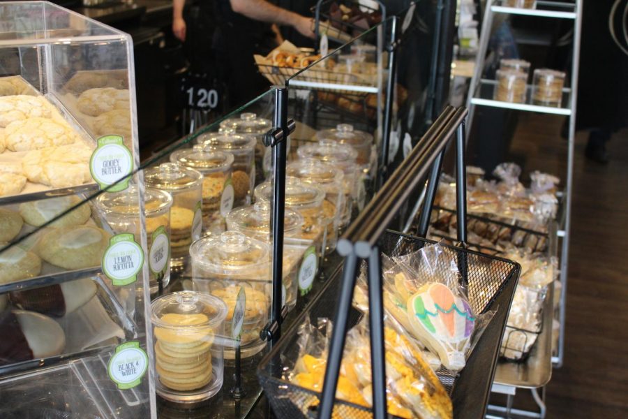Cookies, macarons and muffins glisten in the light within the bakery display case at Colleen's.
