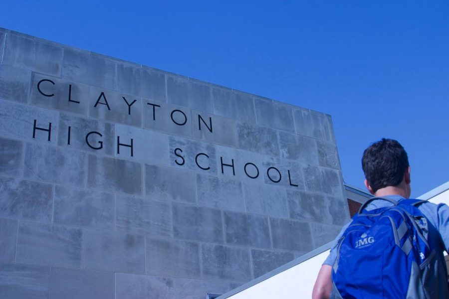 A student in front of Clayton High School.