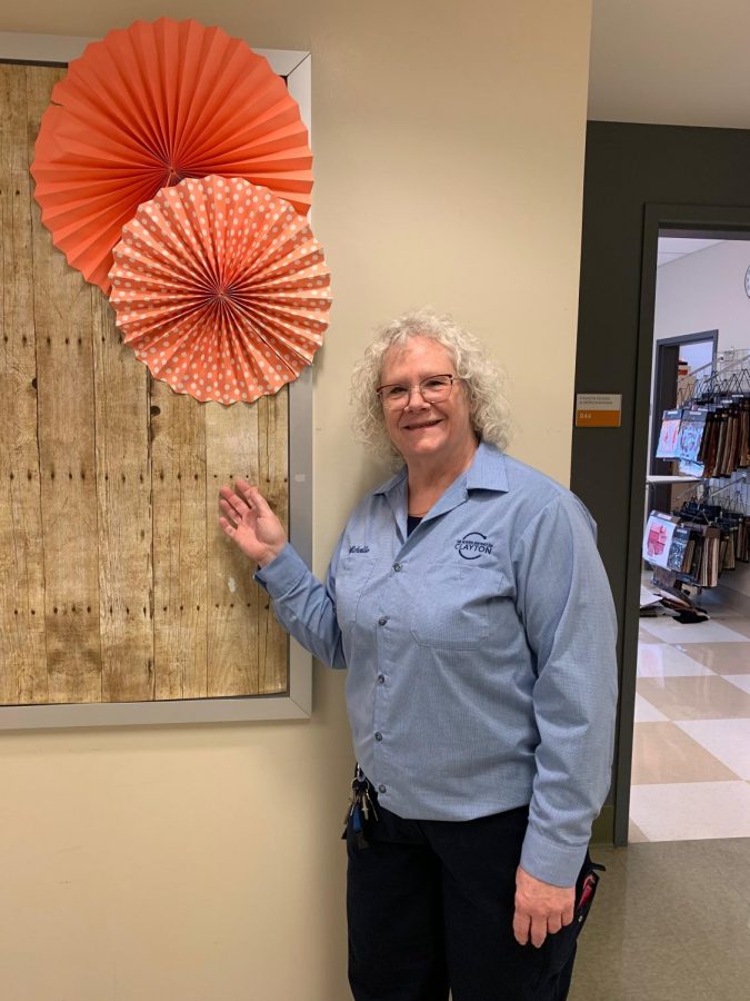 Custodian Michelle Maley stands outside the journalism wing of CHS