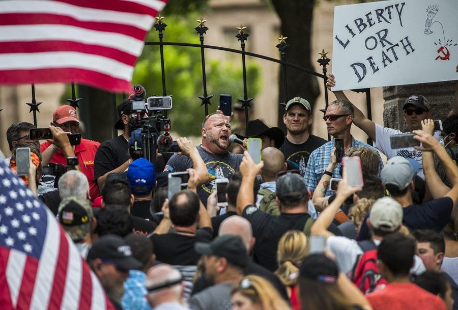 Info Wars founder Alex Jones and nearly 150 un-masked protesters gathered on 11th street and Congress to protest against wearing masks in Texas.