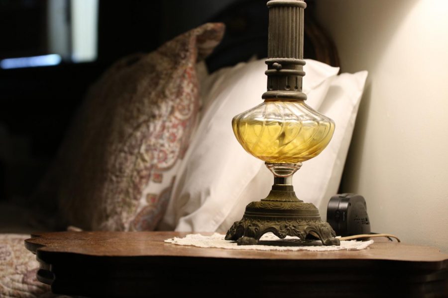 A lamp illuminates a Lemp Mansion suite. Rooms were furnished with antique pieces.