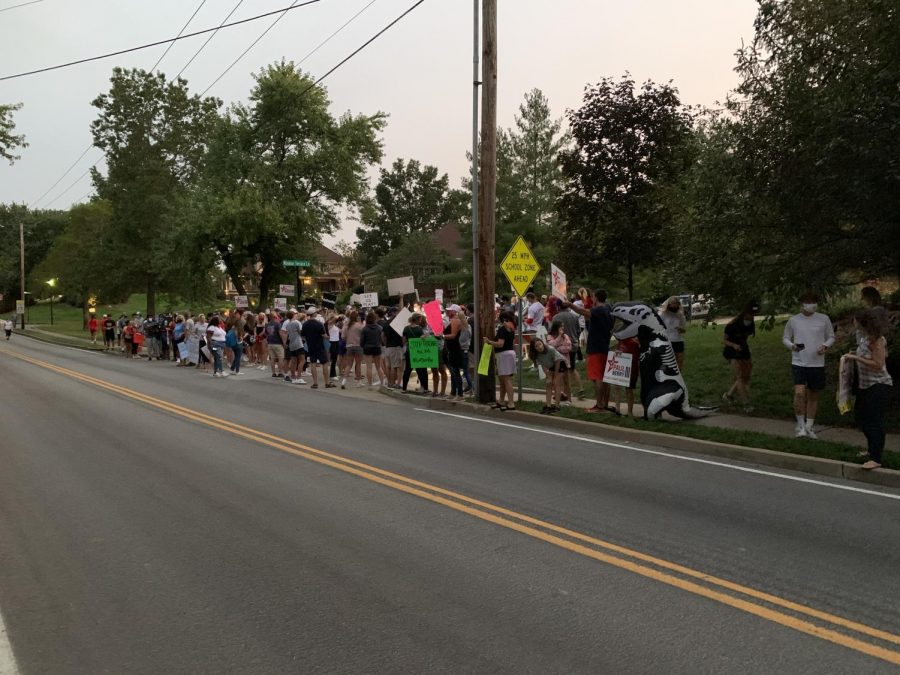 Ralliers group together at the base of Sam Page's street of residence.