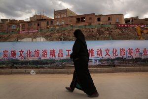 An Uyghur woman walks along an area of reconstruction in Kashgar, China. Many homes in the old urban district of Kashgar are being reconstructed, and many have been raised to build a new park. (Los Angeles Times/MCT)