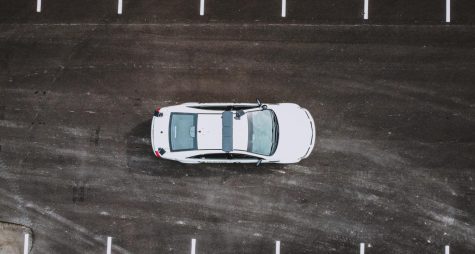 A police car on a road, photo taken from an upwards angle.