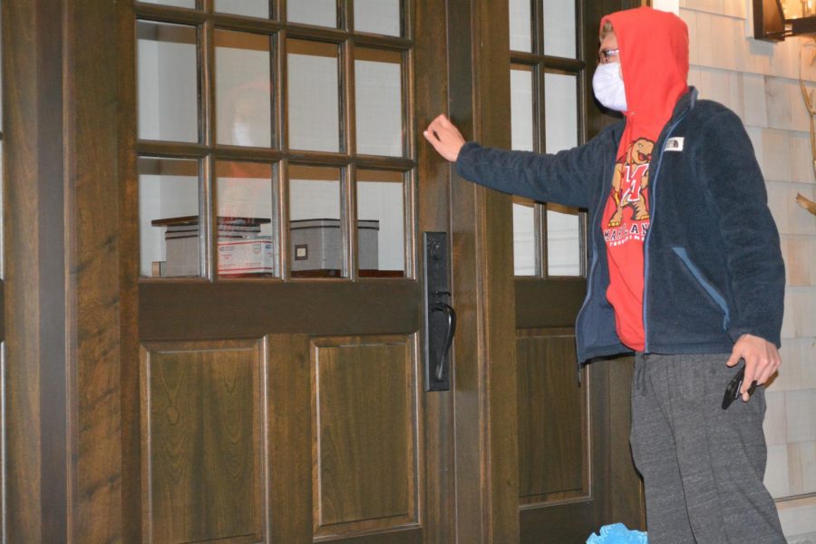 A young man safely deposits a portion of subdivision takeout on a doorstep. 