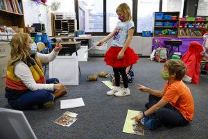 Elementary school students learn at school, having to don masks and keep distance to stay safe during this pandemic