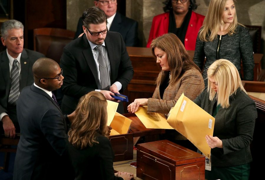 Staffers organize ballots during the counting of electoral votes in Congress on Jan. 6, 2017.