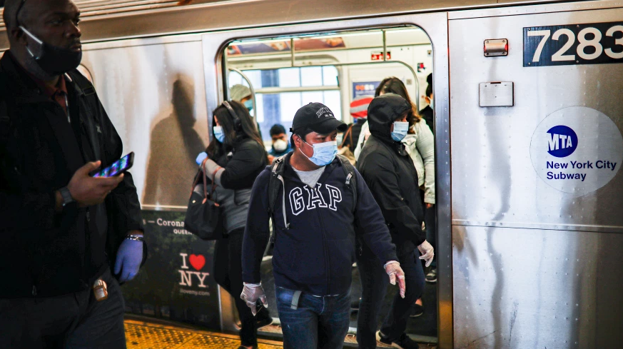 Subway riders exit the train in New York City while wearing masks due to the coronavirus pandemic.  When not wearing a mask, you could get mild symptoms if you combat the virus through viral spread.