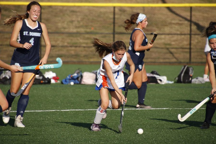 Ruby Nadin dribbles the ball past defenders in a game against St. Dominic