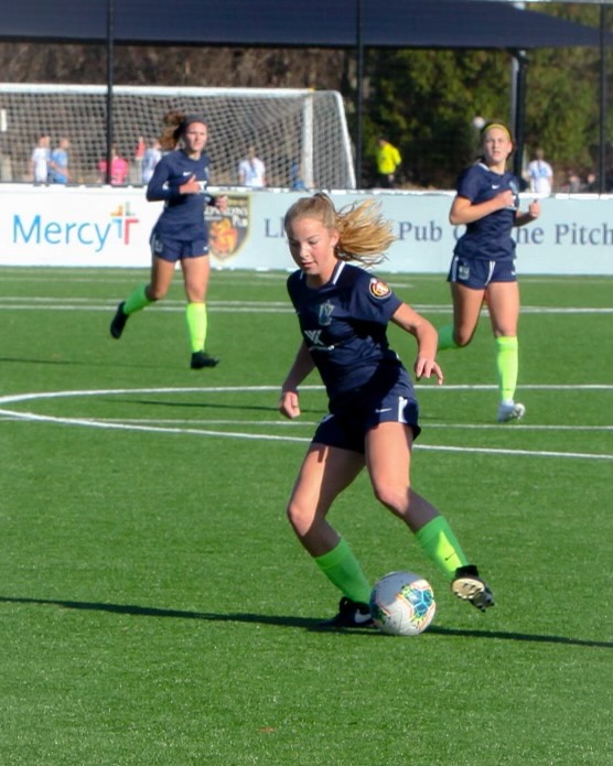 Junior Erin Connolly dribbles the ball in a soccer game for her club team, St. Louis Scott Gallagher. 