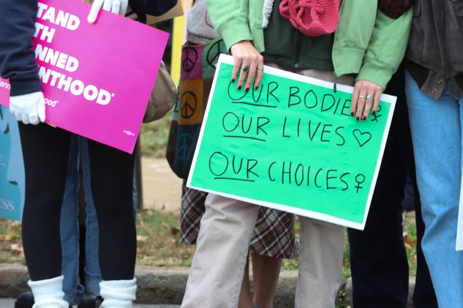Attendee holds sign saying Our Bodies. Our Lives. Our choices.