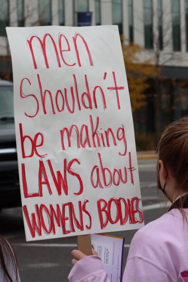 An attendee at the rally for abortion rights holds a sign saying, Men shouldnt be making laws about Womens bodies. 