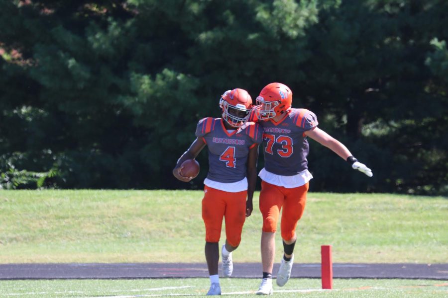 Calvin Swinney (left) celebrating with a teammate after scoring a touchdown during the homecoming game versus Principia.
