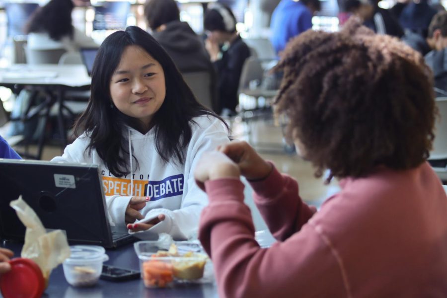 Chs junior Esther Wang works on her computer and talks with a friend during a lunch period in the CHS Commons. 