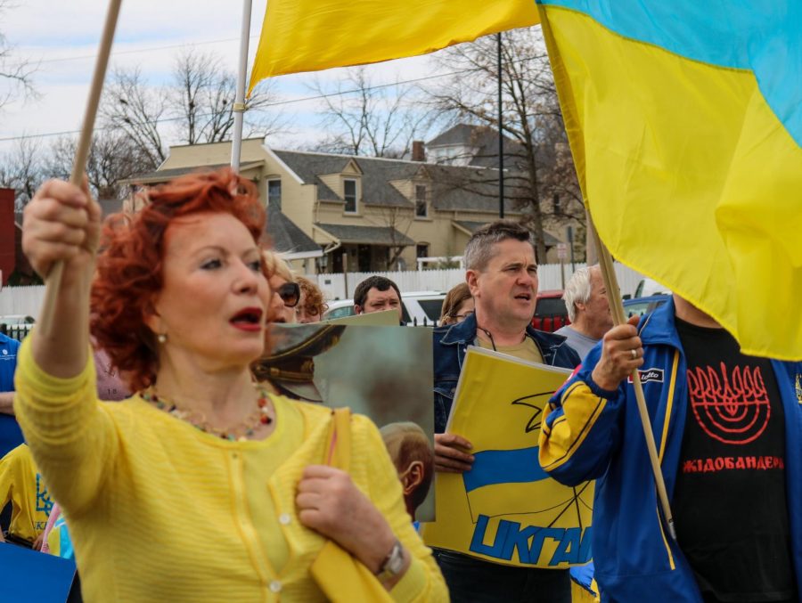 People proudly singing the Ukrainian national anthem as they walk to the pavilion in Frontier Park. 