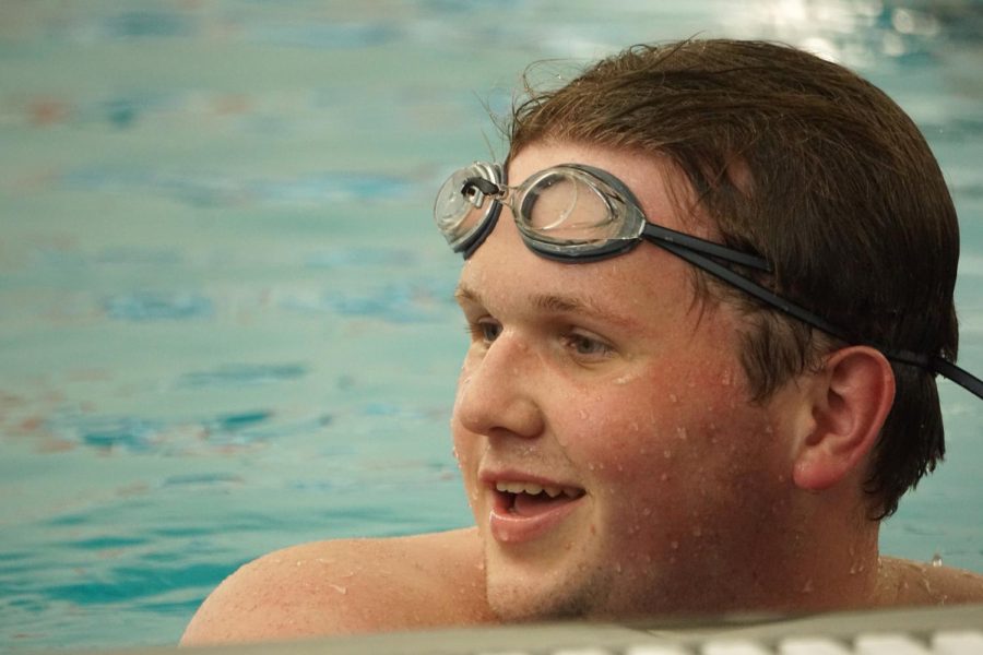 Louis Oge smiles after completing a swimming set. 