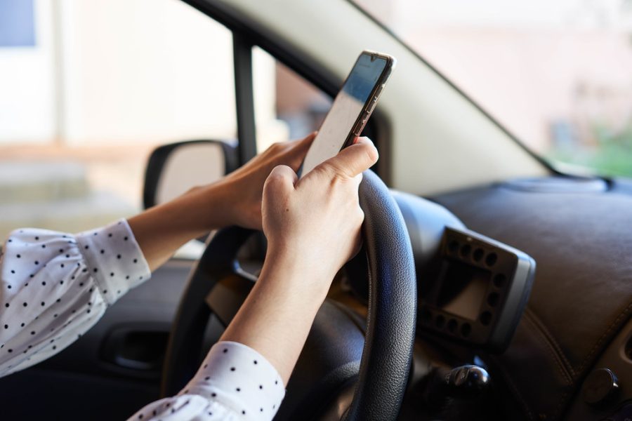 A woman texting on her phone. This activity has been a leading cause of many car accidents around the United States, and globally.