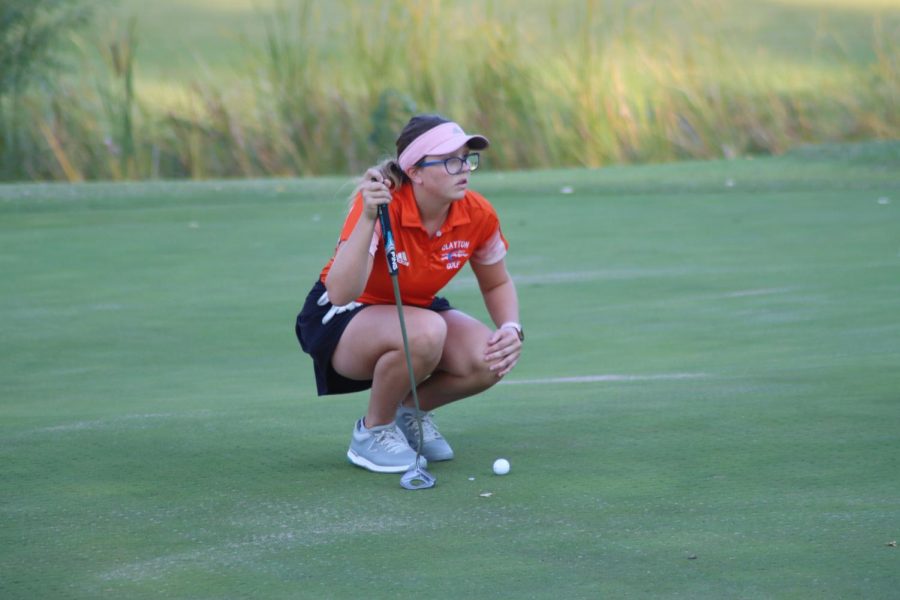 Sophomore Anais Oge competes in an away golf match. 