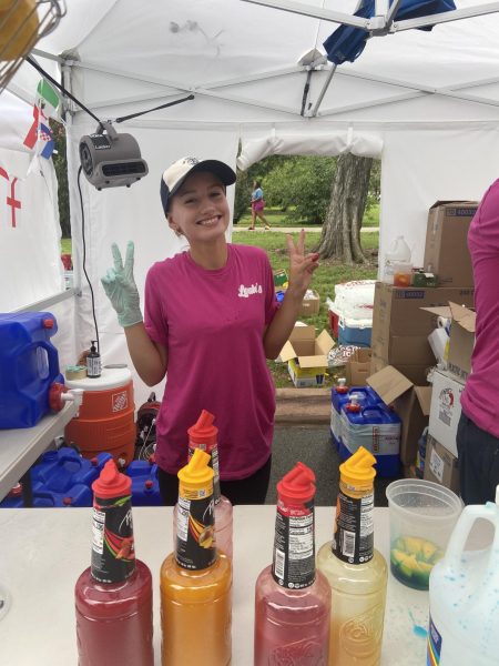CHS Senior Ella McCauley works at the Louies Lemonade booth. The booth sold Mango, regular, and blue raspberry  lemonades to attendees. There were so many diverse people sharing their cultures with others, and it was really cool to be a part of it! said McCauley. 