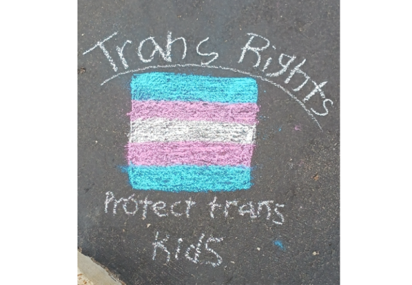 This chalk drawing was created and photographed months before either of these laws went into effect, but its message endures.