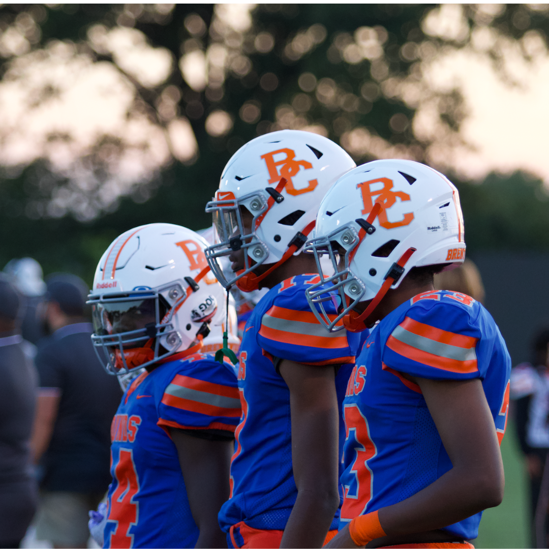 Three Clayton-Brentwood players analyze the field as they stand on the sideline