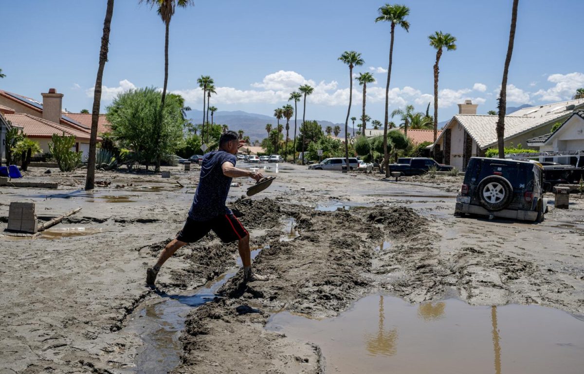 Ronald Mendiola walks barefoot through the mud after checking on his house on Horizon Road on Aug. 22, 2023, in Cathedral City, California. More frequent climate-driven disasters have changed the math for insurers in the state. (Gina Ferazzi/Los Angeles Times/TNS)