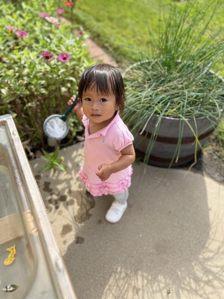 A toddler plays in the outdoor water table. The new space allows lots of opportunity for children to explore, especially when the weather is nice. 