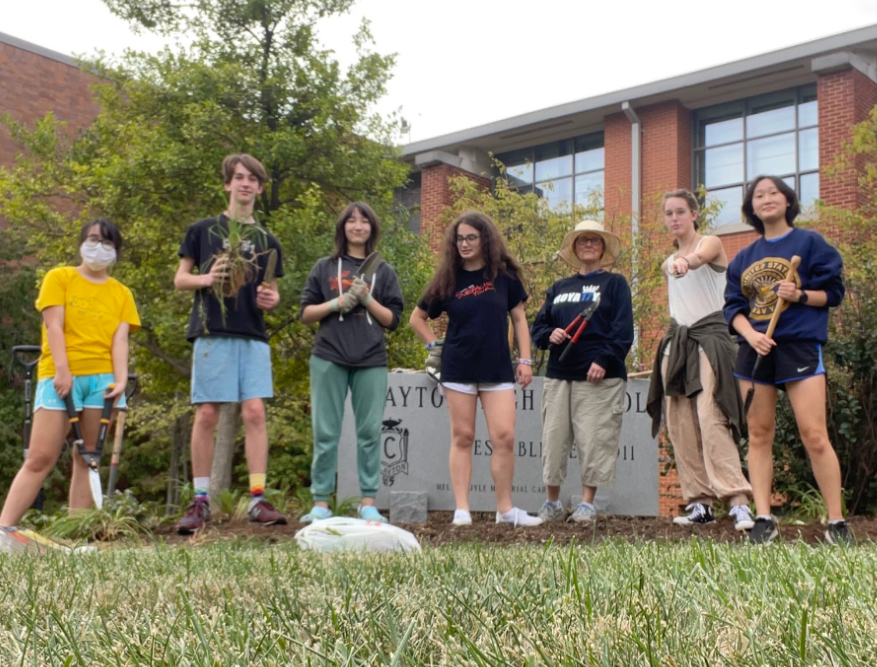 A completed garden: members pose in front of the finished product.