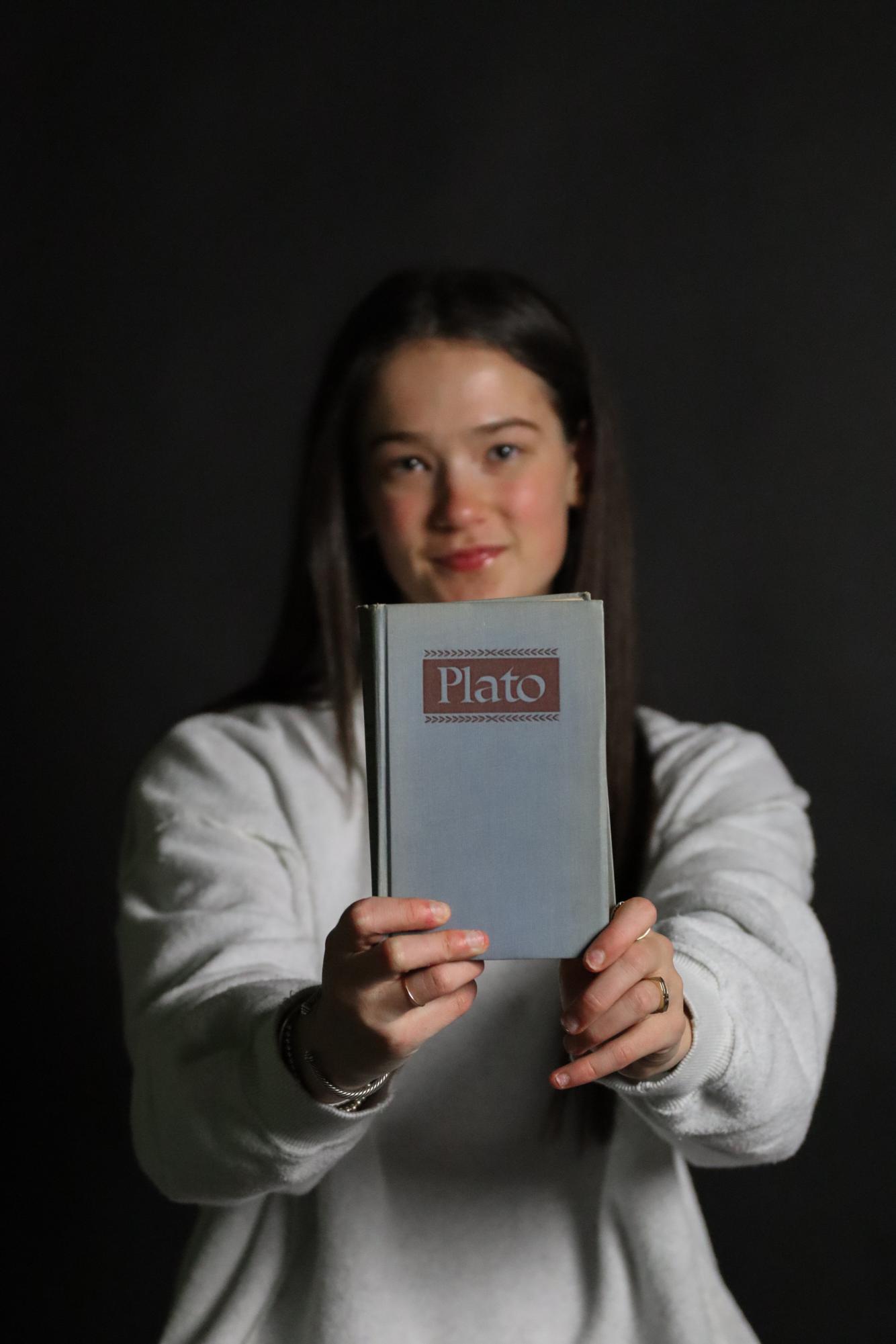 Ivy Slen holds a Plato book which includes The Allegory of The Cave. The book has been in her family for decades.