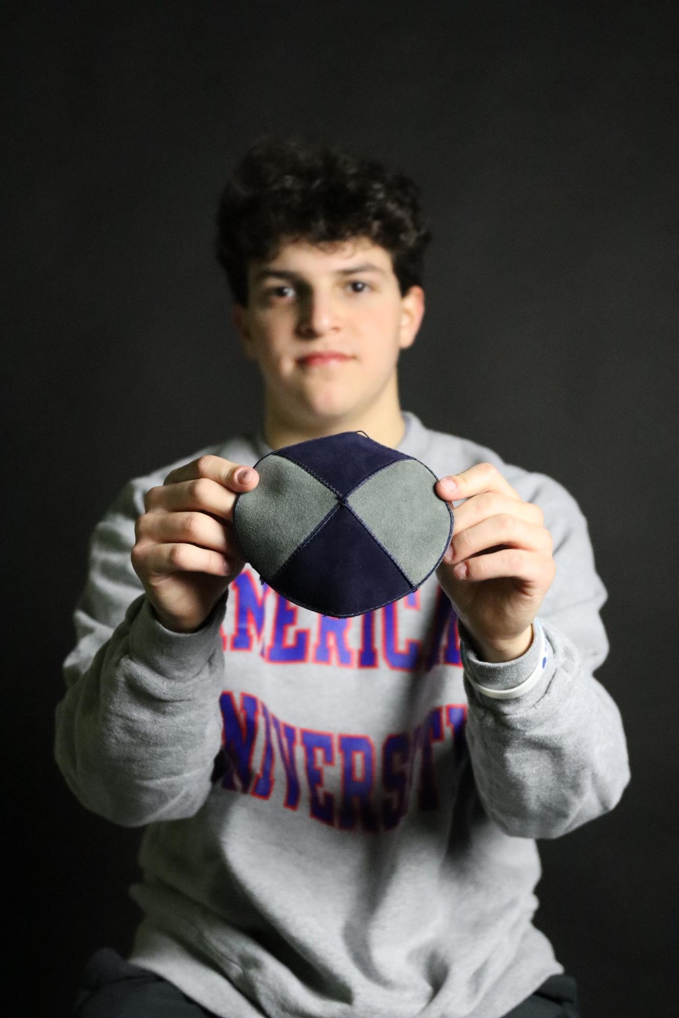 Micah Lotsoff holds his kippah, or yamaka, from his Bar Mitzvah. He wears it every time he attends services.