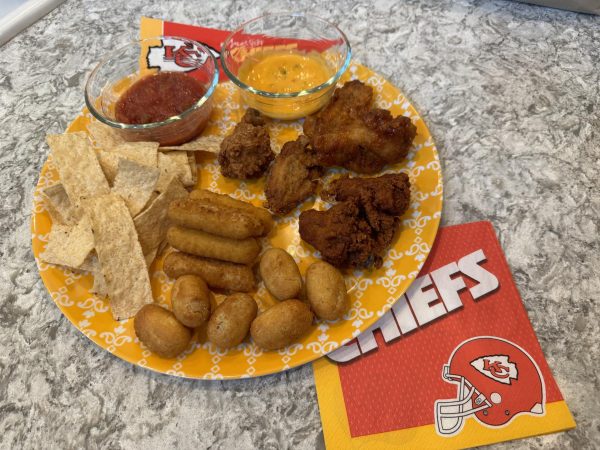 The food: A grand platter of Super Bowl foods, consisting of queso, wings, corn dogs, mozzarella sticks, chips and salsa, in a clockwise direction. 