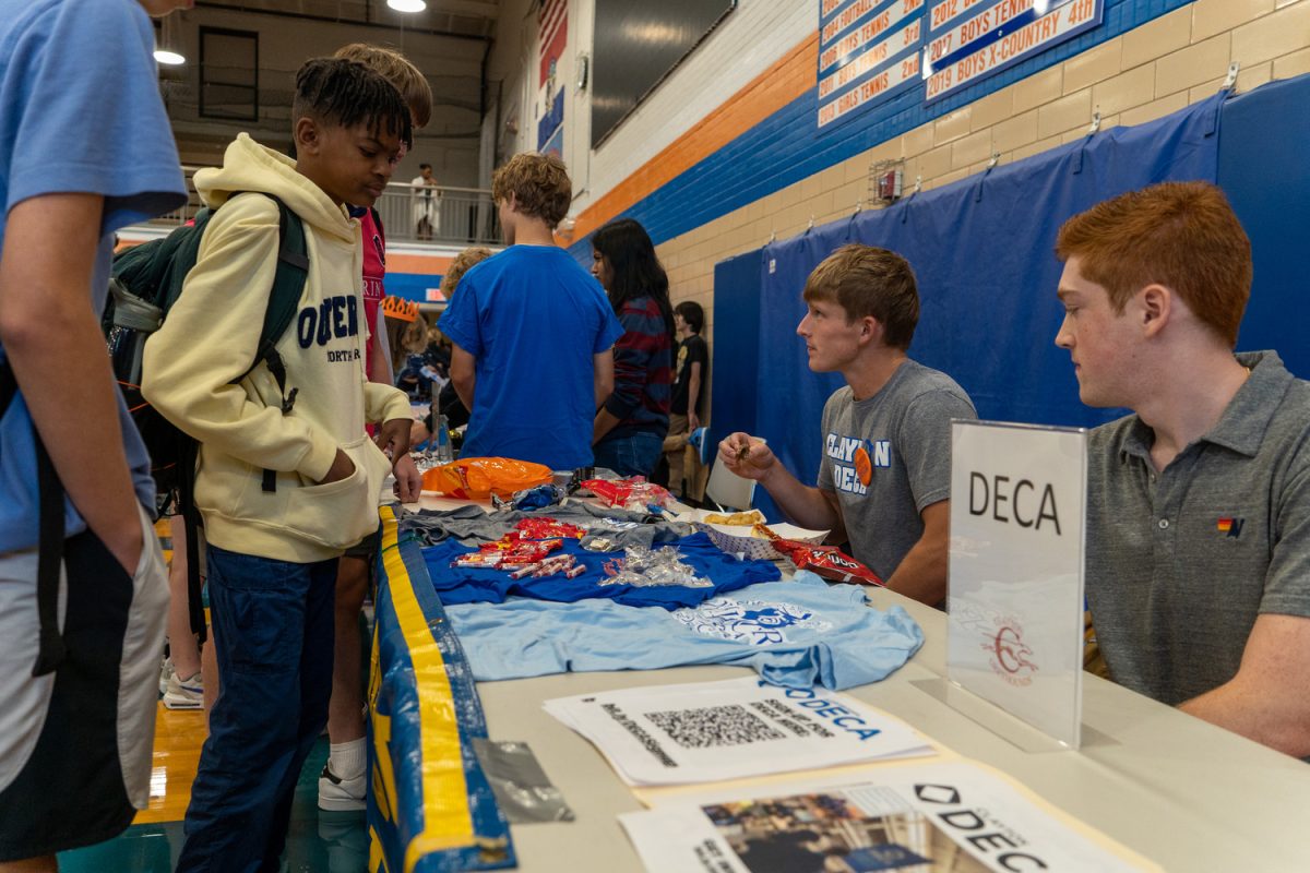 DECA hosts a stand at the Activities Fair on Aug. 25, 2023. Seniors Beacan Mottl and Zack Srenco encourage students into joining DECA.
