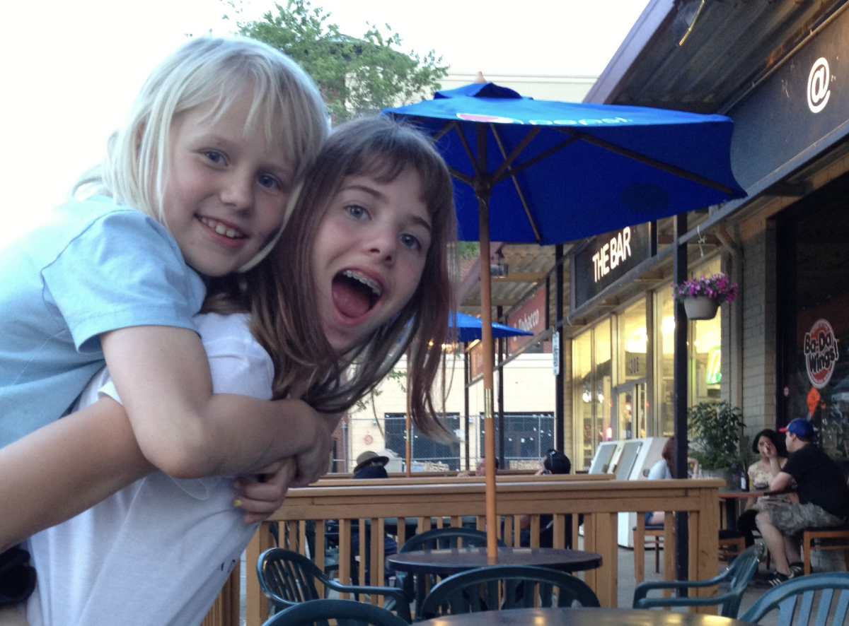 Sidra's sister giving her a piggyback ride