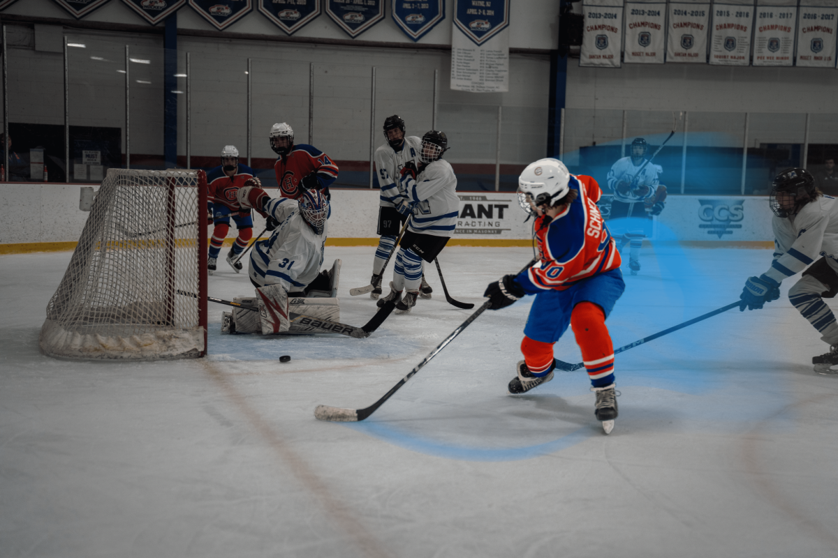 Will Schneider shoots the puck