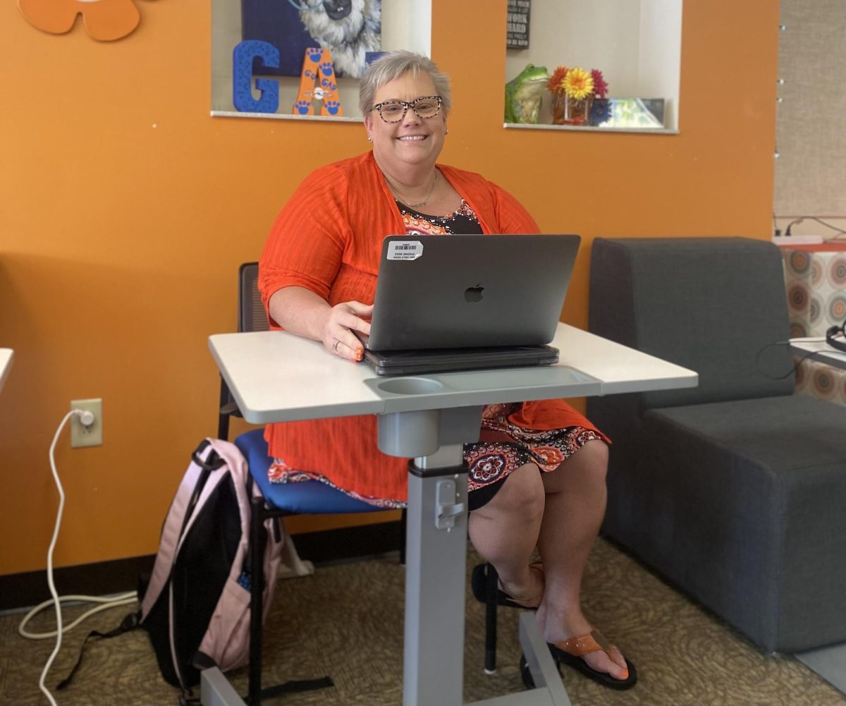 During fifth hour, Alternative Education Program Director Joyce Bell helps a student with their writing. 