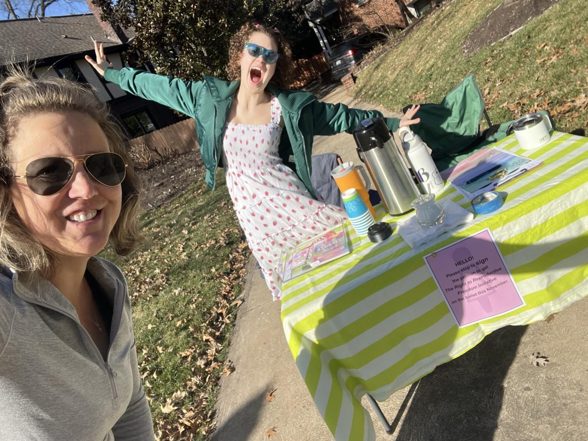 Schulz and her daughter gather signatures on a beautiful day outside their house. They collected about 100 signatures. Photo courtesy of Schulz.