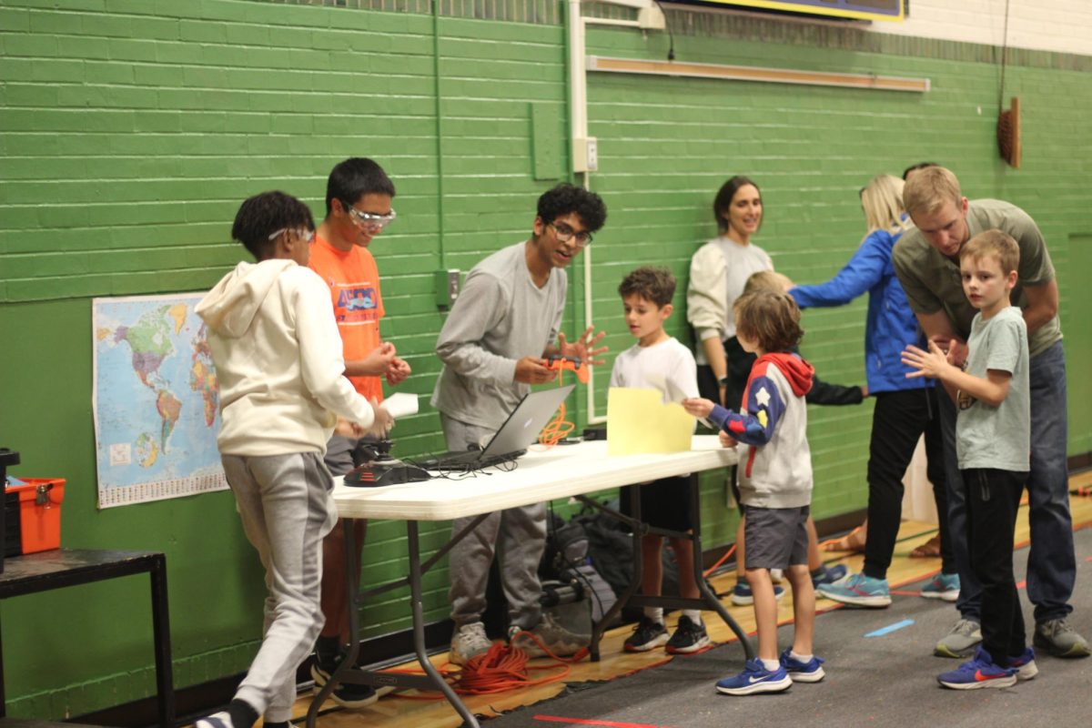 Senior Saaleh Poovathumkadavil talks to students about the importance of the Robohounds. "Outreach creates interest in robotics, and that's great for our team—it inspires kids to have something to work toward in the future and build skills for jobs after high school and maybe college,” Poovathumkadavil said.