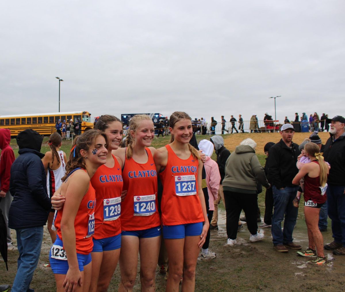 Senior Anna McAndrew celebrating her state finish with teammates Cesarine Cross, Analee Miller, and Ella Welch. Despite a rugged terrain, the team would finish 8th, and McAndrew would finish 11th overall individually. 
