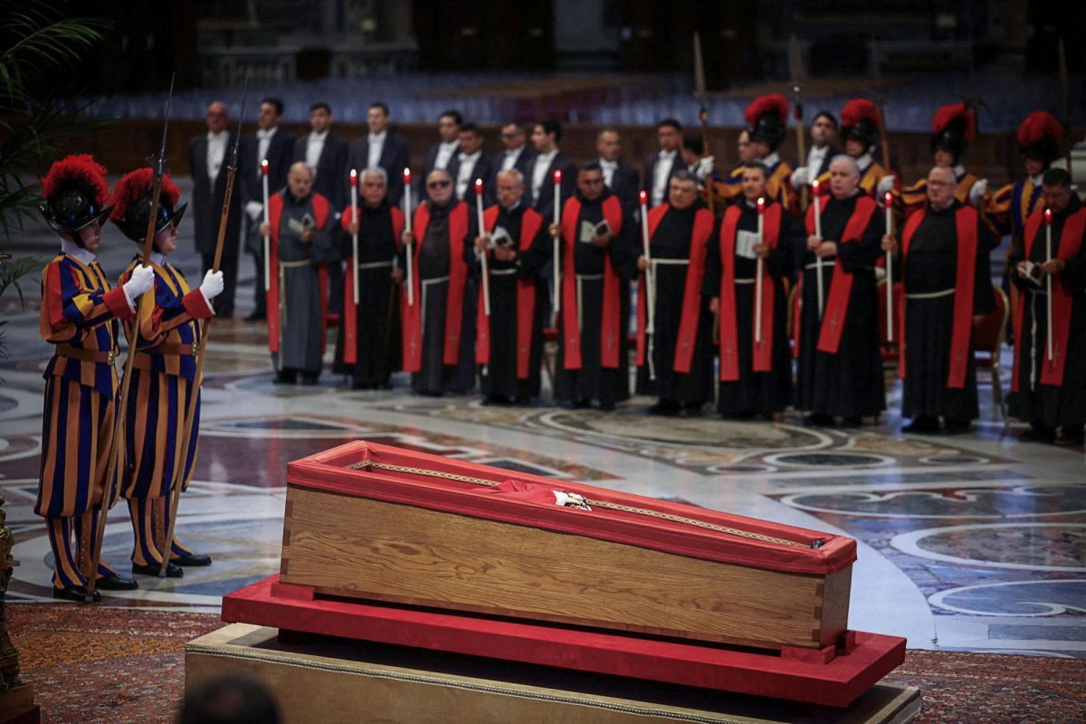 Members of the Swiss Guard stand next to the coffin containing Pope Francis' body, on the day of the translation of his body, in St. Peter's Basilica at the Vatican, April 23, 2025. REUTERS/Yara Nardi