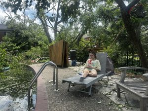 Sophomore Audrey Simanowitz sits in her father's favorite chair, which was nearly lost in the tornado.