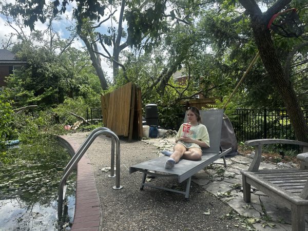 Sophomore Audrey Simanowitz sits in her father's favorite chair, which was nearly lost in the tornado.