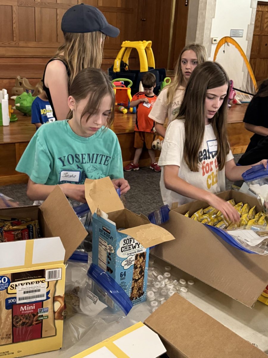 Fifth graders Sasha Kotets and Sawyer Evans  pack care bags for community workers.
