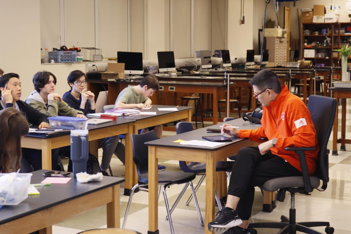 Gabe de la Paz goes over a homework assignment with his third period Honors Freshman Physics class. 
